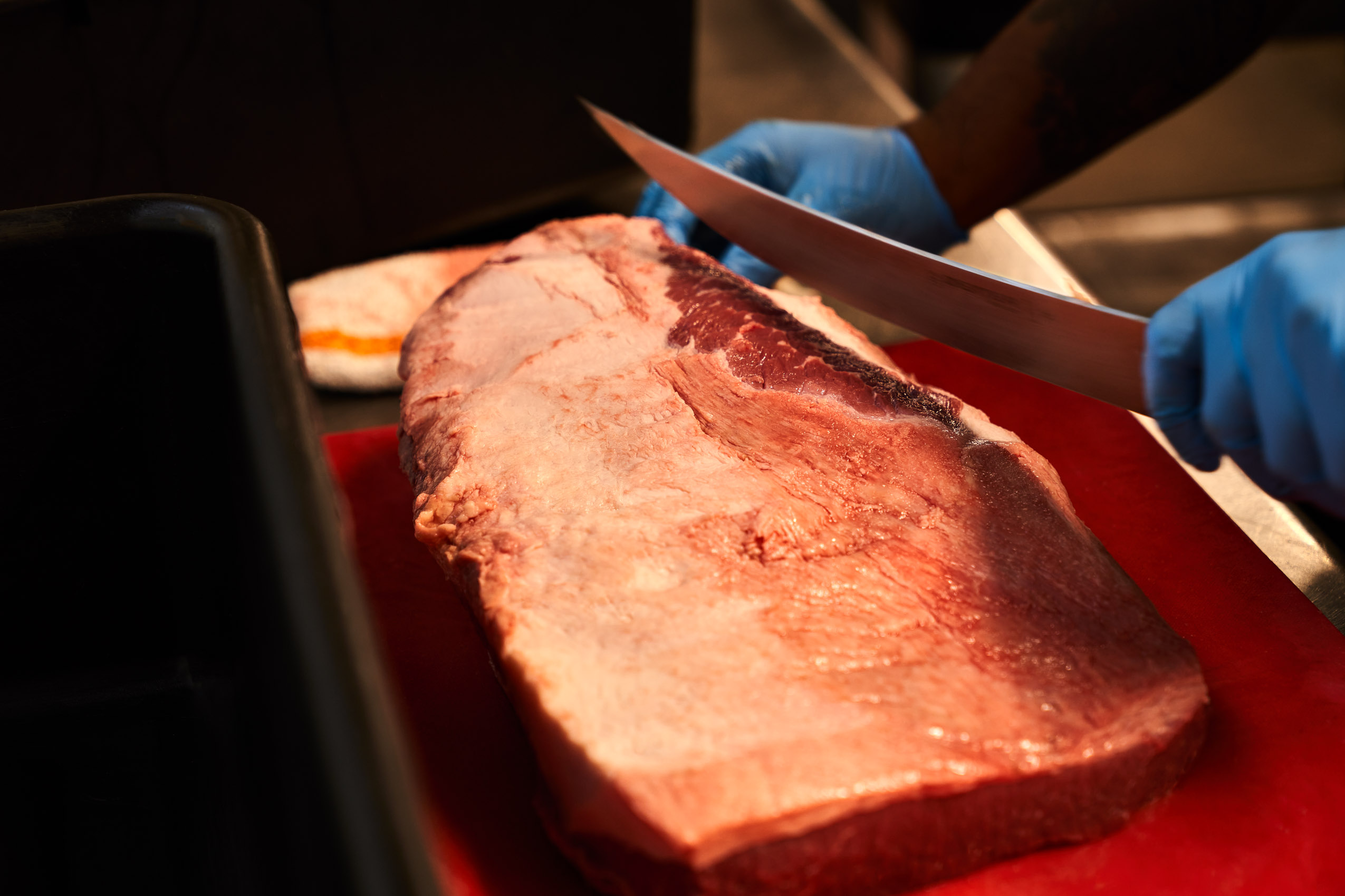 Brisket being trimmed prior to smoking at Southern Junction BBQ in Buffalo NY
