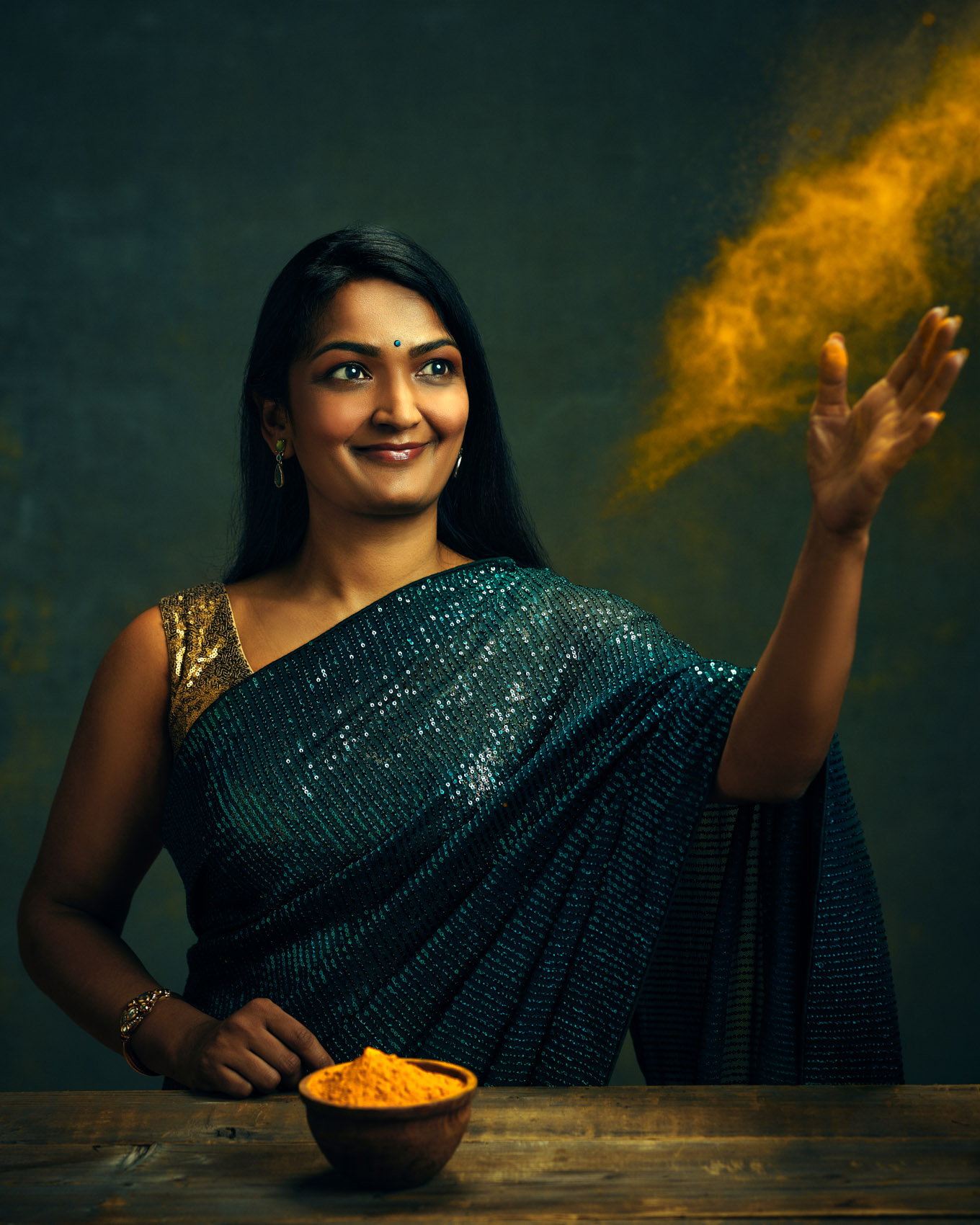 Buffalo NY chef and Indian food educator Smita Chutke Tossing Turmeric into the air