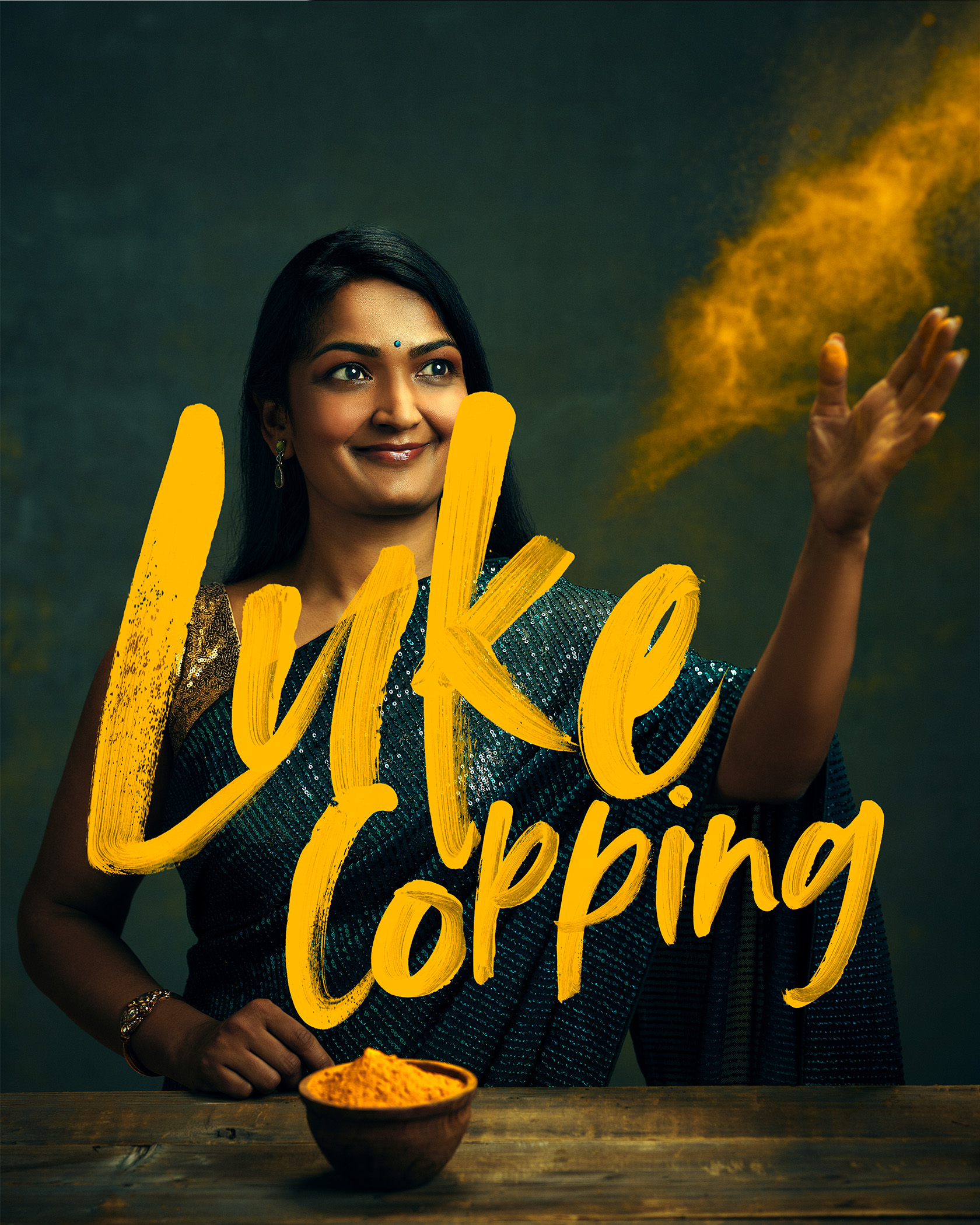 Buffalo NY Chef Smita Chutke Throws spices into the air - overlayed with the Luke Copping Photography Logo 