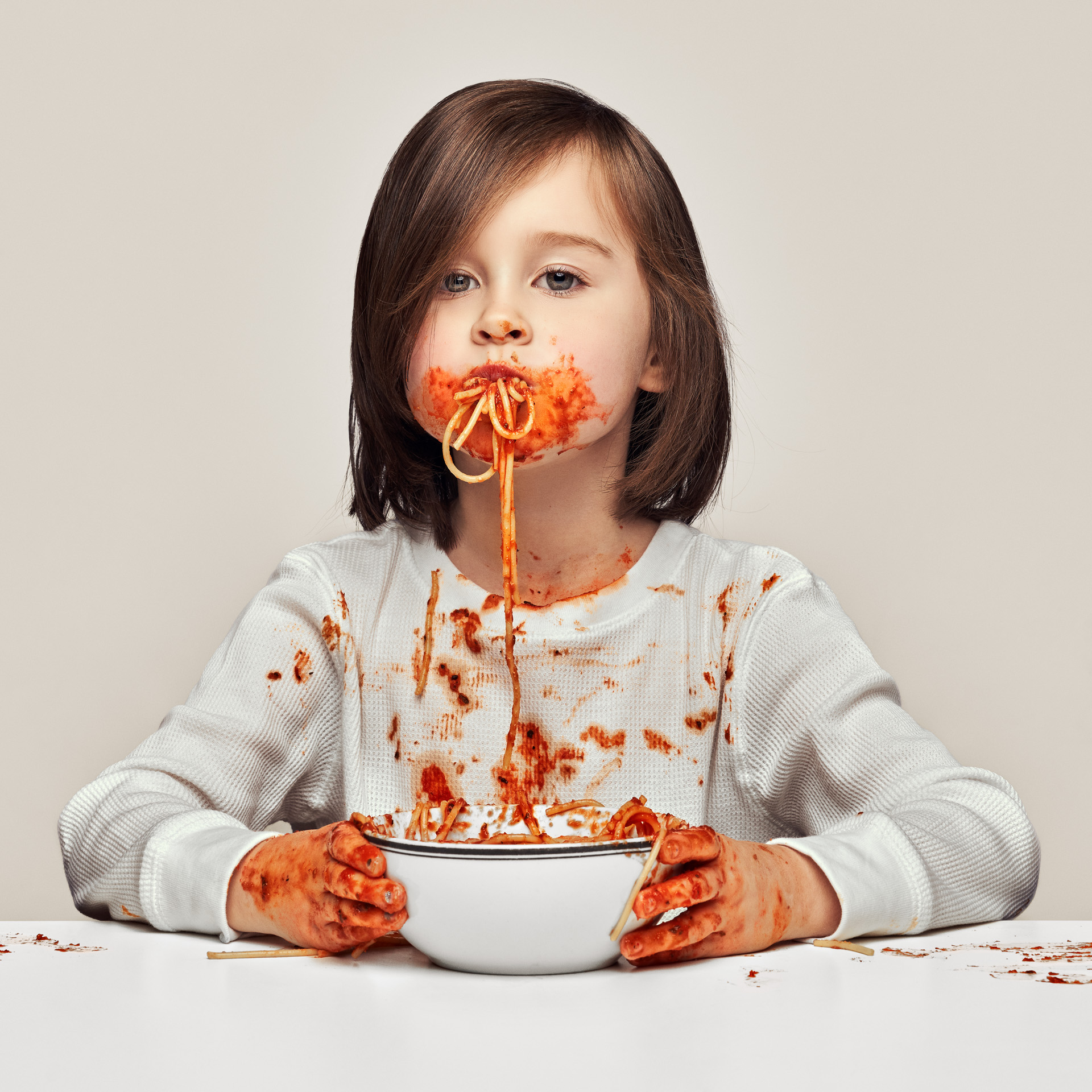 Commercial portrait of Vivienne making a. mess with Spaghetti