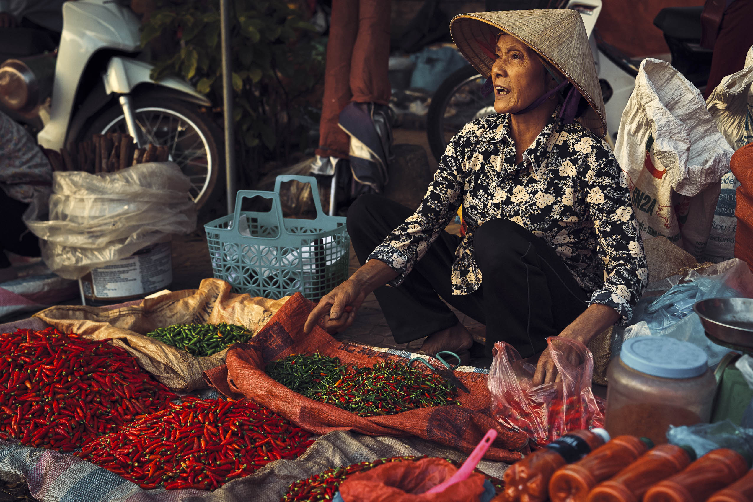 WOMAN SELLING CHILES AND HOT SAUCE - BAC HA MARKET